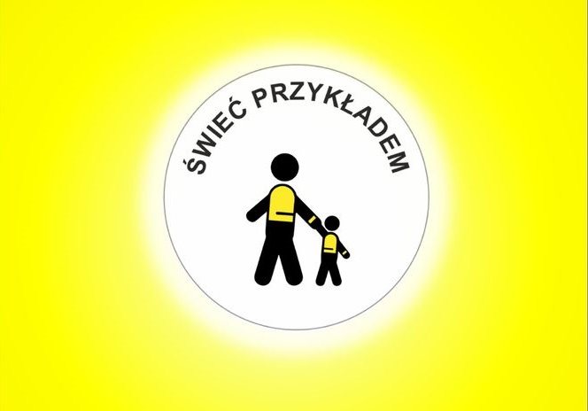 Grafika przedstawiająca w białym okręgu postać dorosłej osoby trzymającą za rękę dziecko, w górnej częsci okręgu napis: "ŚWIEĆ PRZYKŁADEM". Tło grafiki w kolorze żółtym.