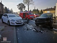 Miejsce wypadku. Na pierwszym planie widać dwa rozbite samochody, na drugim planie samochod straży pożarnej