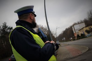 Na zdjęciu zbliżenie na policjanta, który obserwuje rejon przejścia dla pieszych