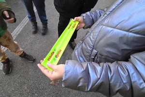 Na zdjęciu widzimy policjanta rozdającego odblaski