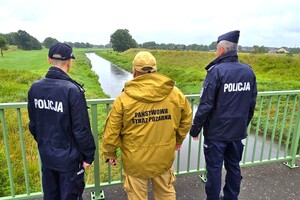 Na zdjęciu widzimy policjanta oraz strażaka pożarnego